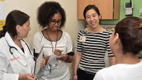 Drs. and Students talking to a patient.
